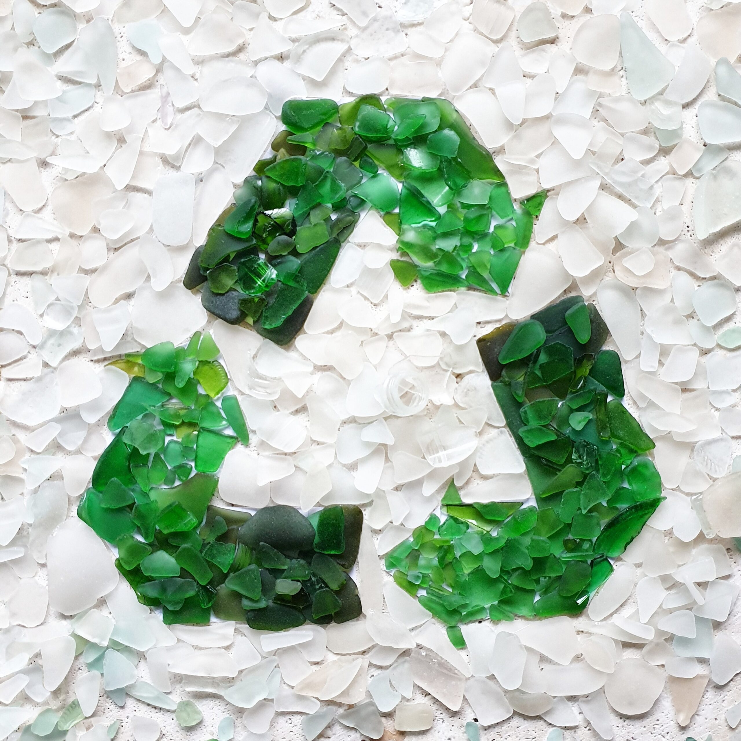 recycle-symbol-made-from-broken-glass-collected-fr-YQ3MYDZ